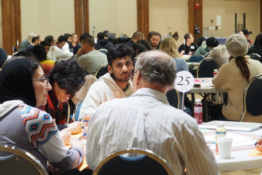 A group sitting at a table talking at Better Together 2023