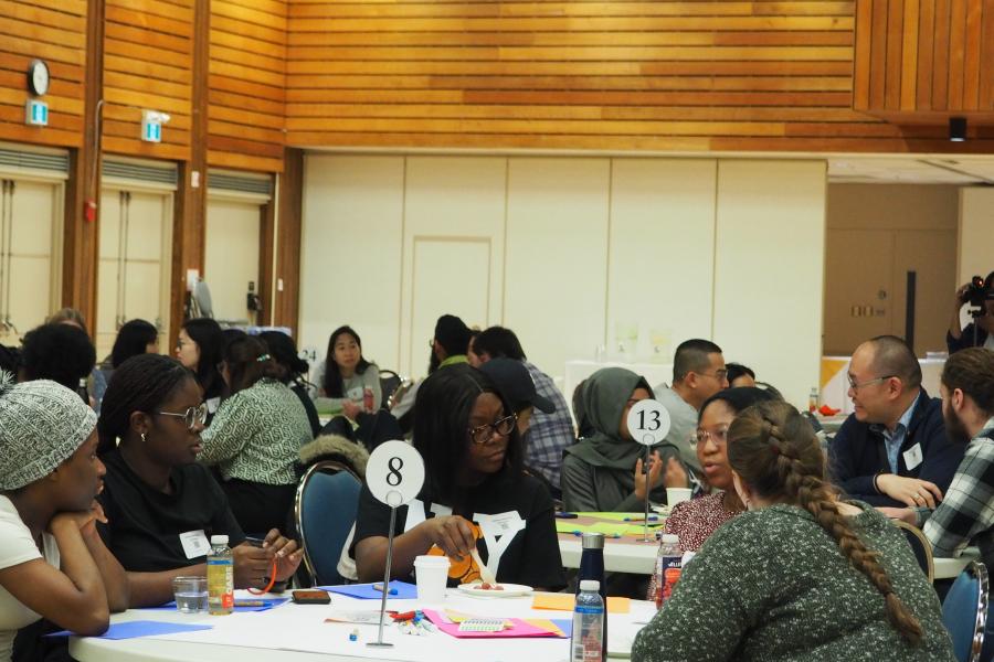 A group sitting at a table talking at Better Together 2023