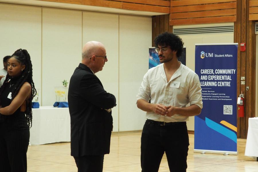 Two people standing having a discussion at Better Together 2023