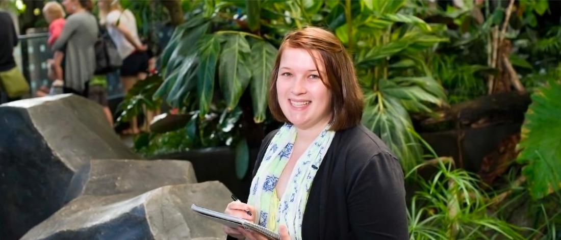 A woman sits in a tropical house at the Assiniboine Park Zoo. 