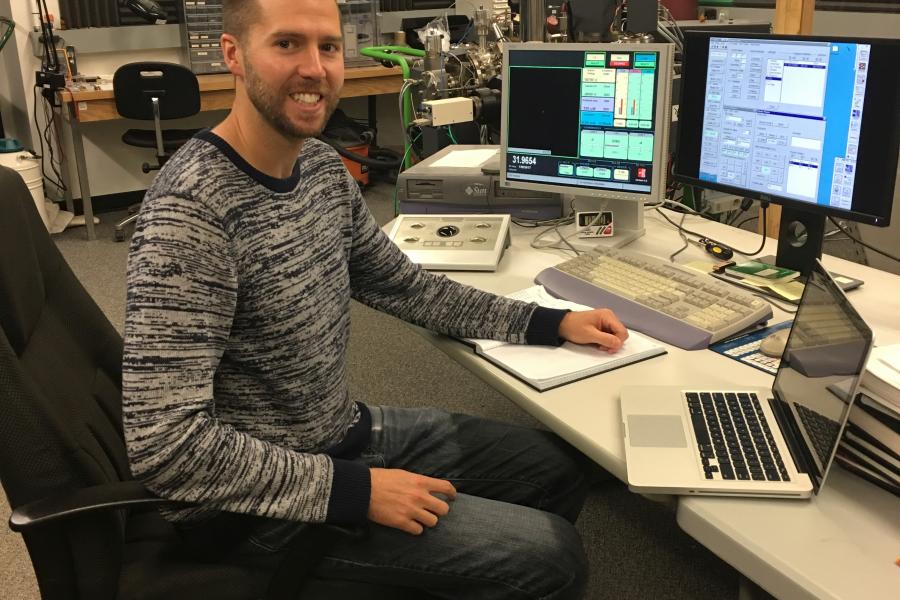 Ryan sharpe sitting at his desk in his lab.