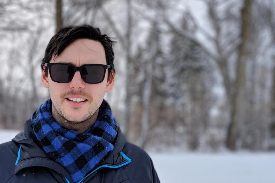 Doctor david landry standout outside by trees.