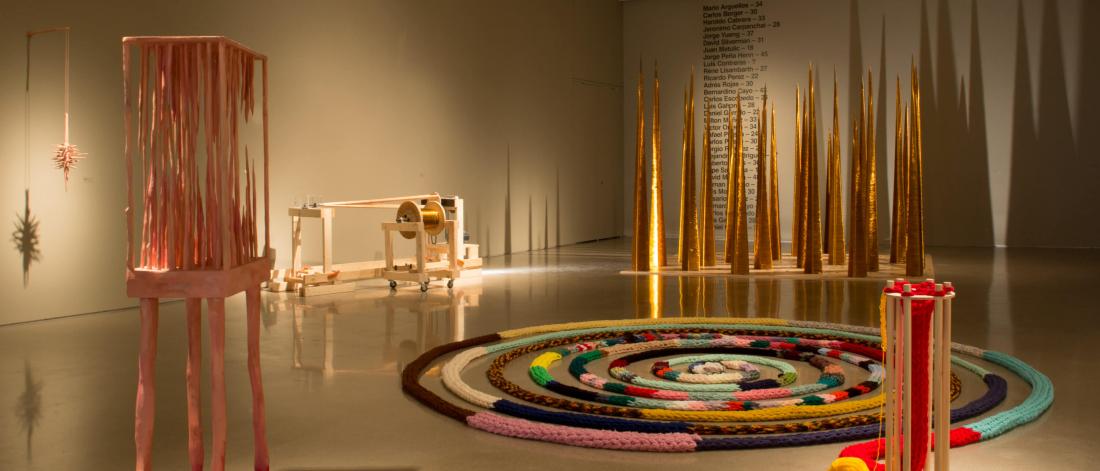 The School of Art Gallery featuring a display of Master of Fine Art student work including a hand knit loop rug, and tall wire wrapped narrow pyramid structures.