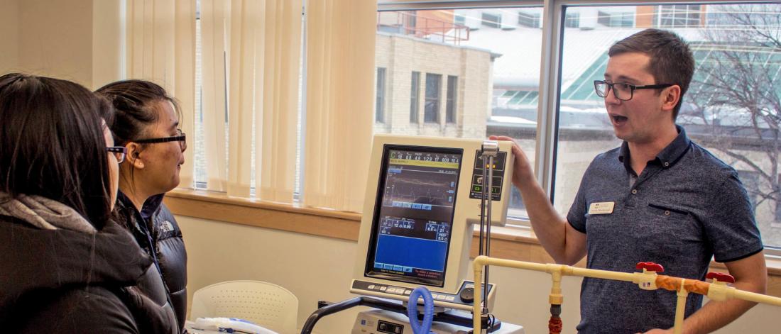 A respiratory therapist performs a breathing demonstration.