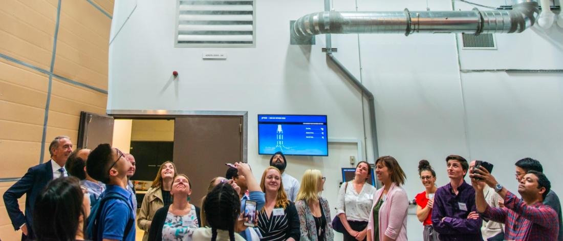 Students receive a tour of a factory.