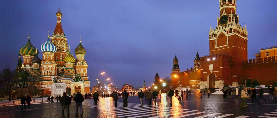 A scenic late evening view of brightly lit buildings in Moscow.