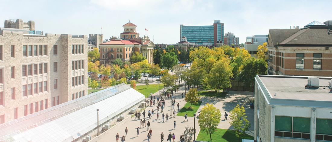 A rooftop photo of students walking to and from class on a sunny summer day at the University of Manitoba Fort Garry campus.