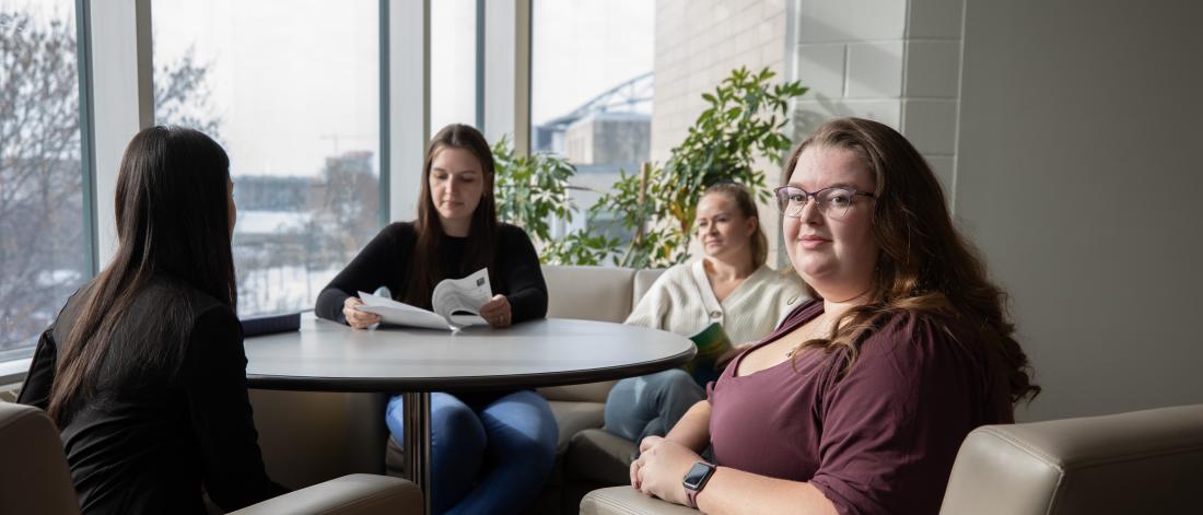 Group of students seated by window
