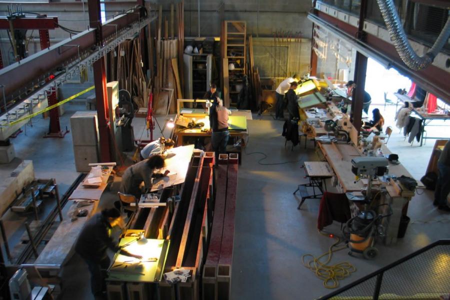 An interior view of the Centre for Architectural Structures and Technology lab. with students working on various projects.