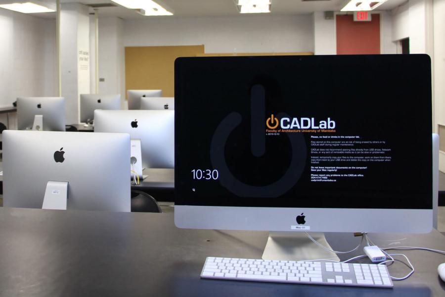 An interior view of the CAD lab with several rows of iMac computers lines up along long narrow tables.