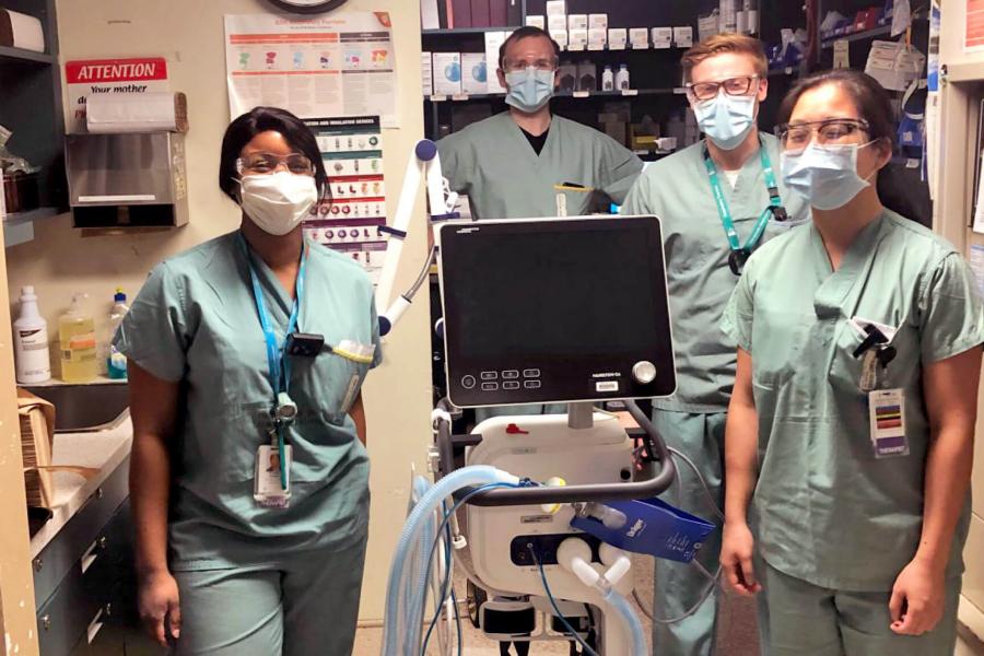 Three Respiratory Therapy students dressed in scrubs and wearing masks gain clinical experience in the field.