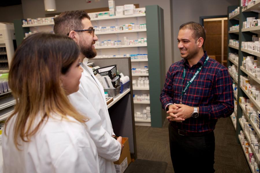 Preceptor discusses pharmacy with two new pharmacy students.