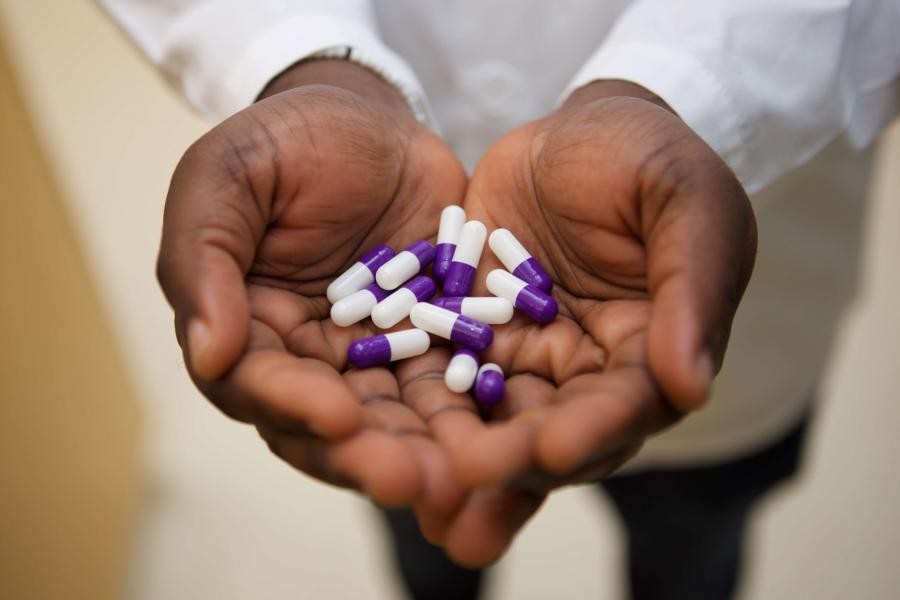 Drug capsules in a researcher's hands.