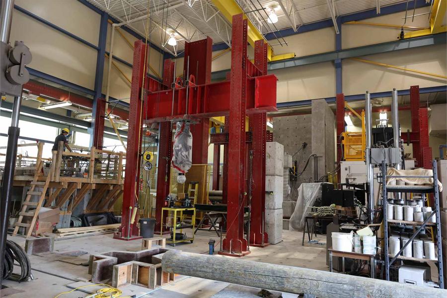 A large workshop with high ceilings and several pieces of heavy metal machinery.