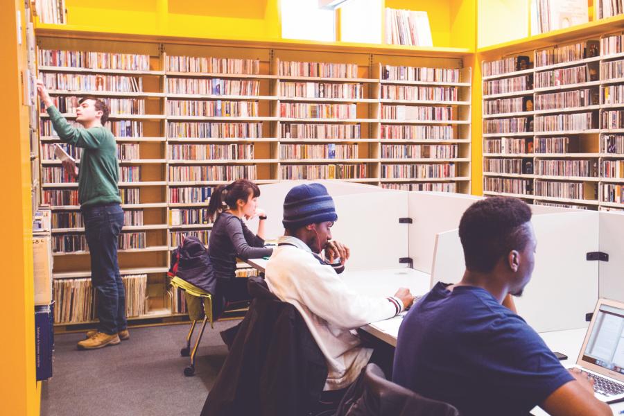 Students sitting down studying in the library