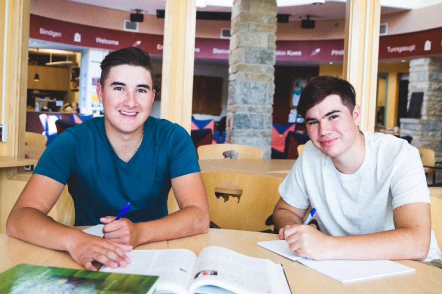 Two students studying in Migizii Agamik Bald Eagle Lodge.