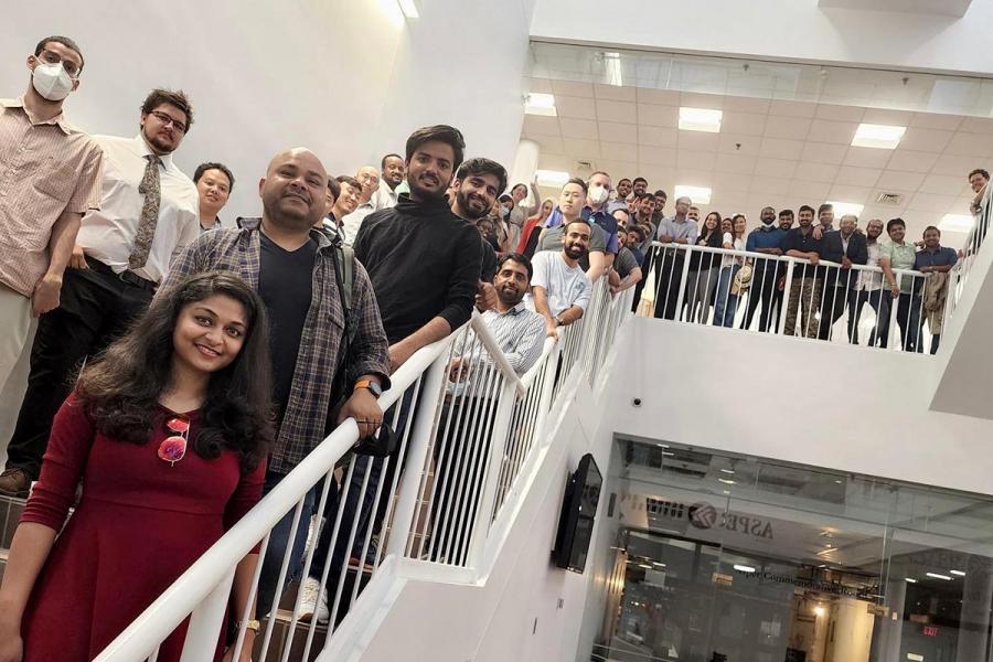 A group of students standing up a stairwell