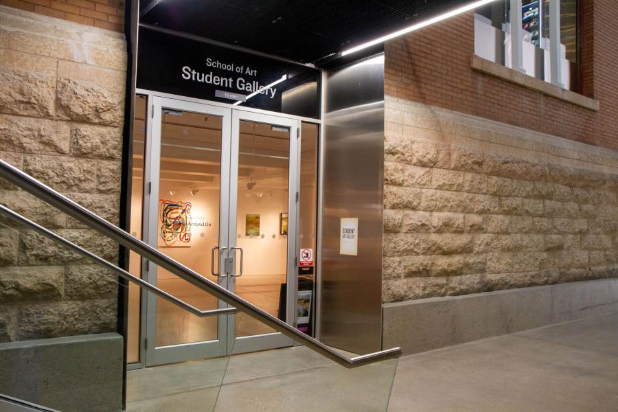 Two glass doors and a brick exterior to the School of Art Student Gallery at the Taché Arts Complex.
