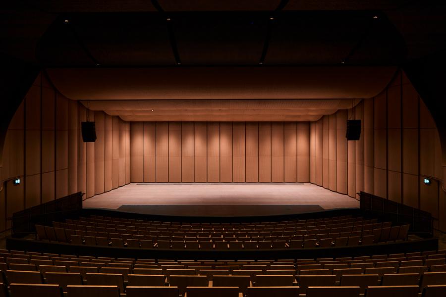An empty Desautels Concert Hall. The lighting is dim and the stage looks large while empty.
