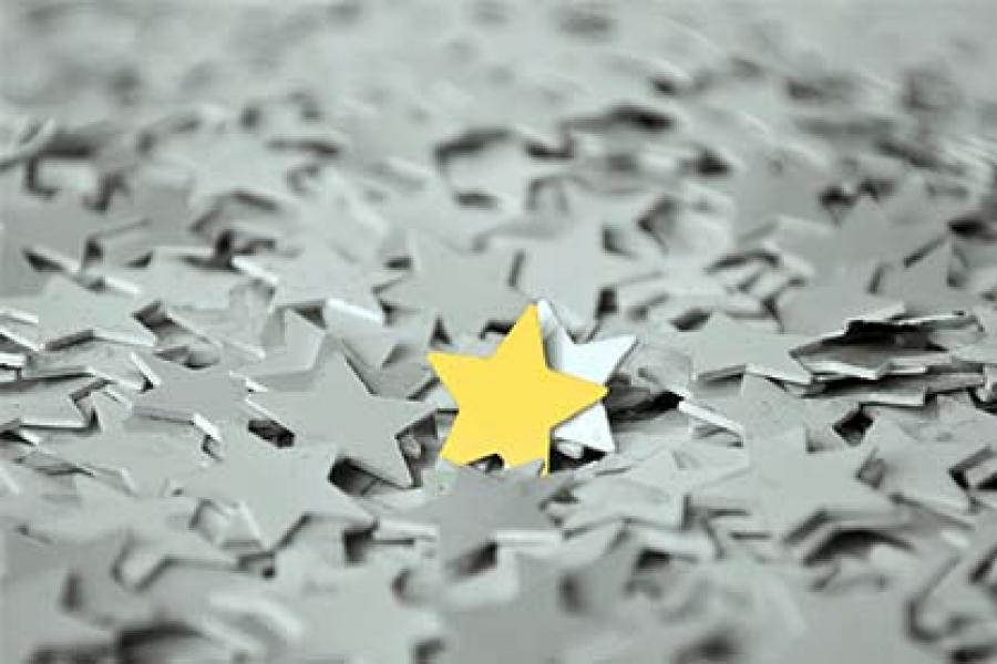 The yellow star is in the middle of the grey and white stars.