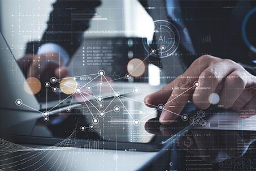 A businessman is using technology devices in a modern office setting with a digital interface overlay, representing data analytics and connectivity.