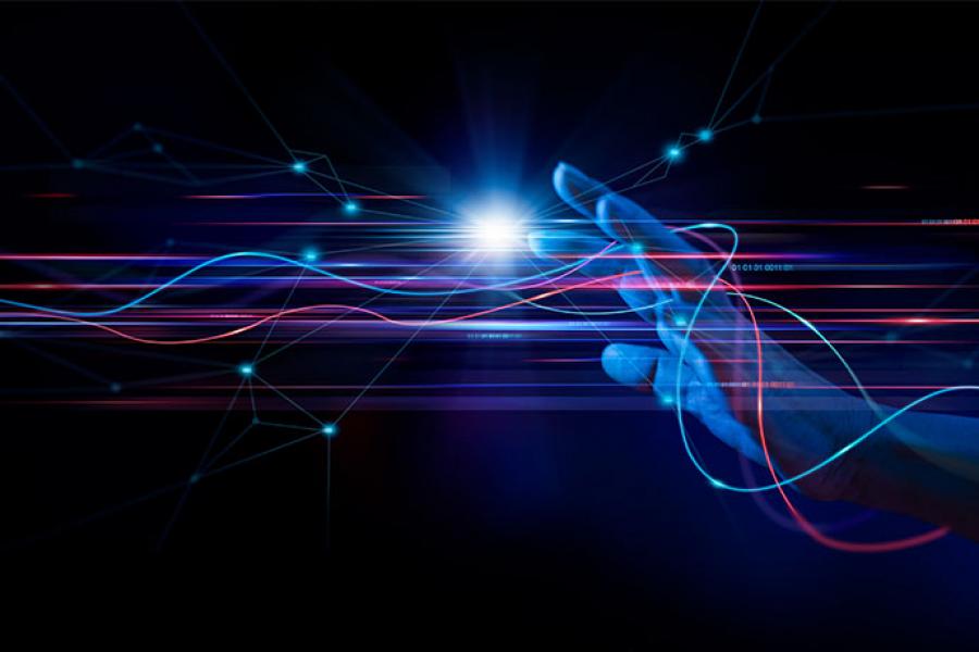 A hand is reaching for a bright blue glowing orb, with vibrant, colorful light streaks swirling around it, all set against a dark background.