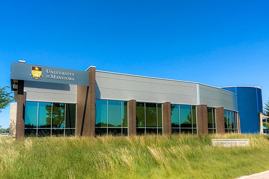 Long brown building with flowing grass and blue sky located at 137 Innovation Drive