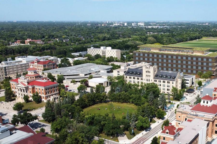 Aerial view of Fort Garry campus featuring the Duckworth quad and surrounding buildings, with The Point lands in the distance.. 