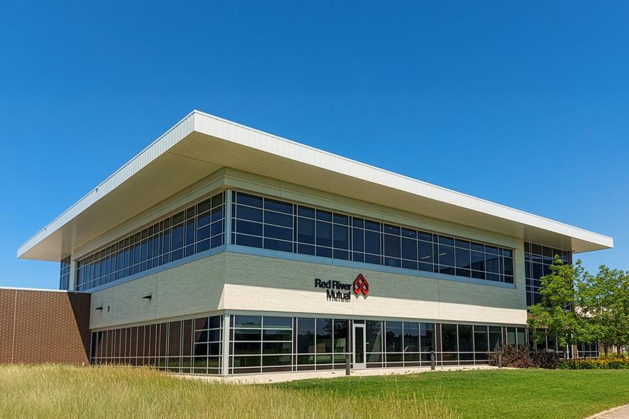 Large, two-level building with many windows located at One Research Road.