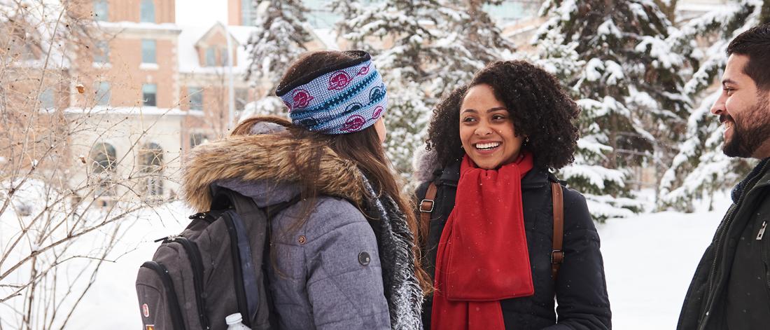 students talking outside on campus in winter