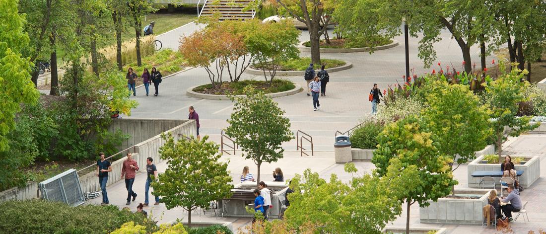 aerial view of students walking outside on fort garry campus in late summer