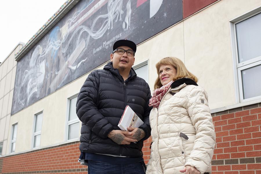 a man and a woman standing outside a building