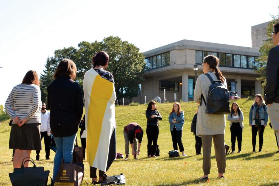 students standing around in a circle outside