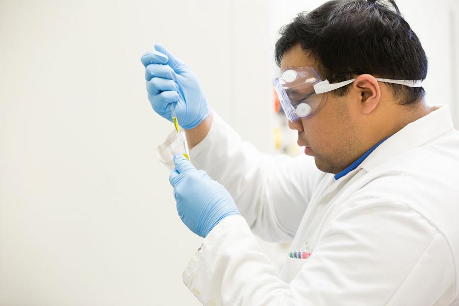 a man conducting lab work with a syringe