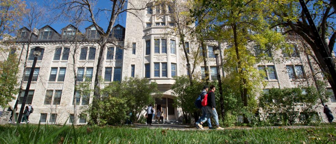 Students walking in front of the Tache Arts building.