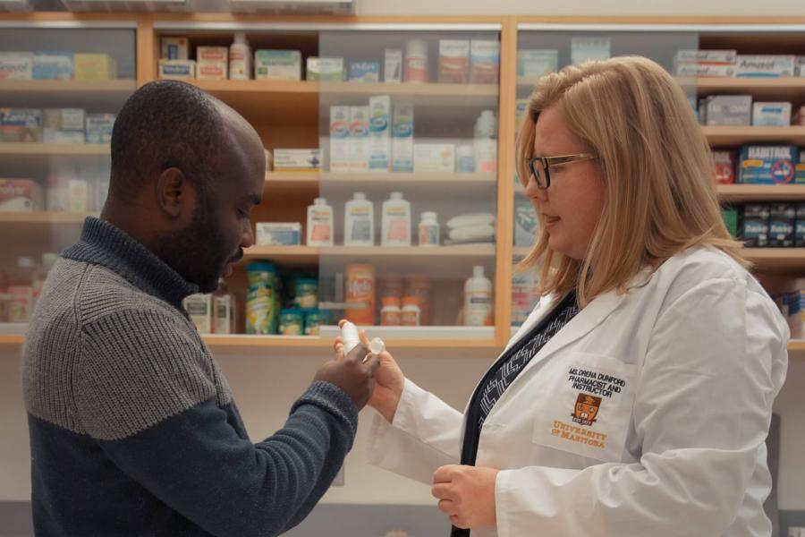 A pharmacist discusses a prescription with a customer