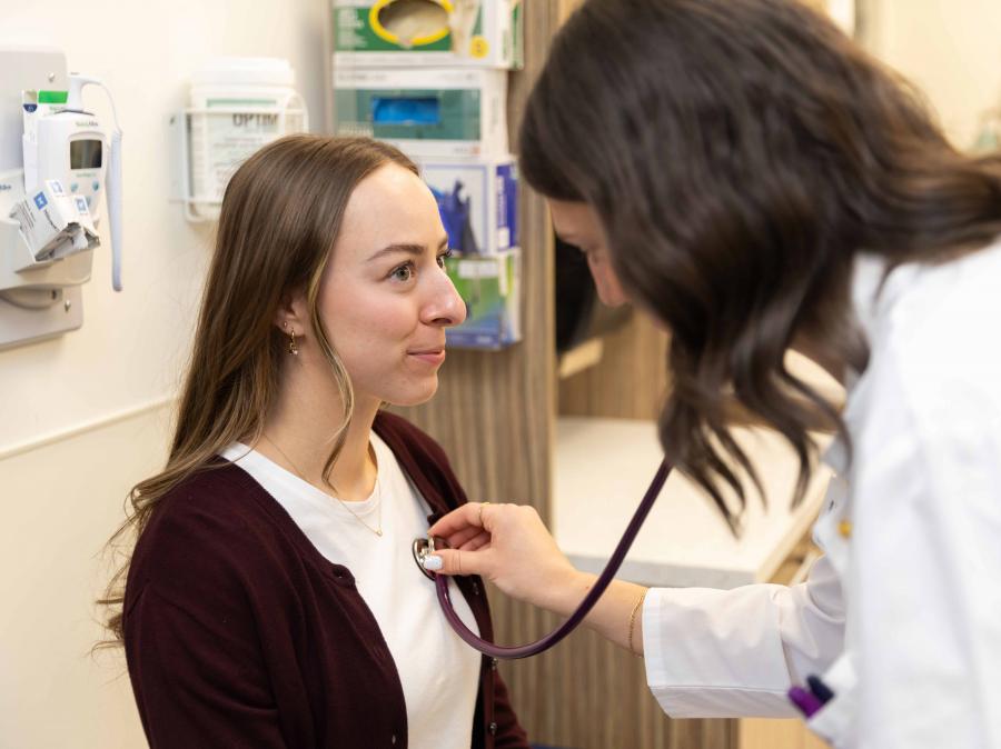 A physician checks a patients heart rate