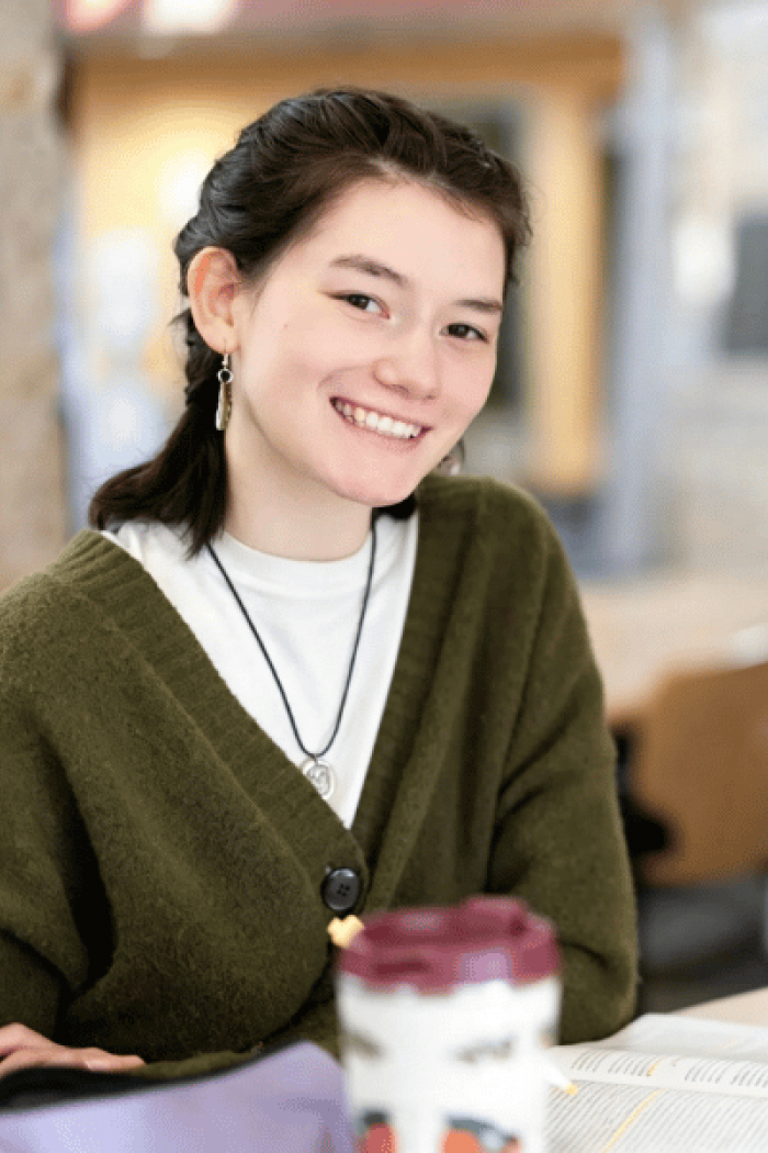 An Indigenous student studying on campus.