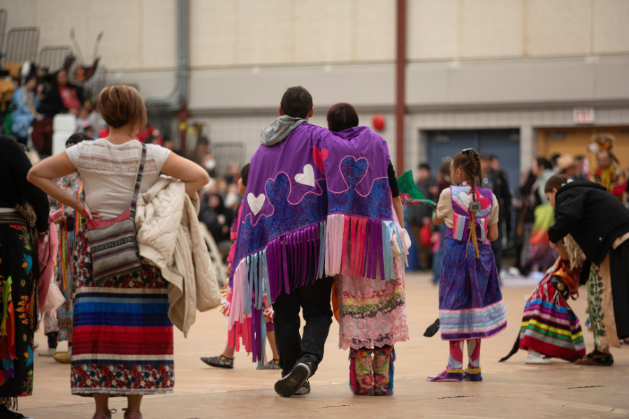 Two participants sharing a quiet moment at a pow wow