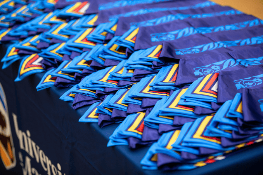 Indigenous graduation stoles neatly arranged on a table at the University of Manitoba.