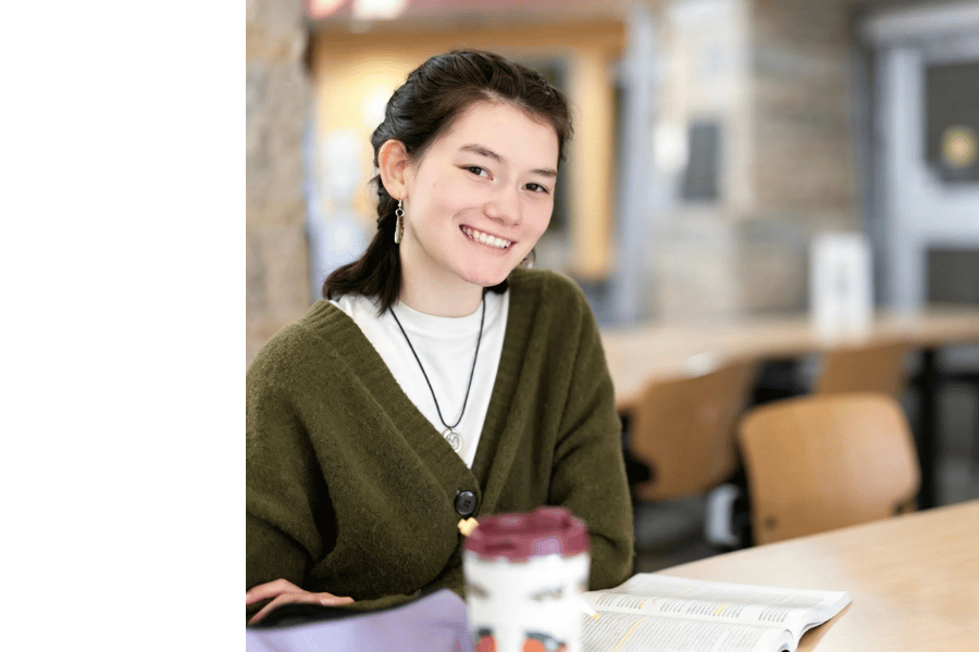 An Indigenous student studying on campus.