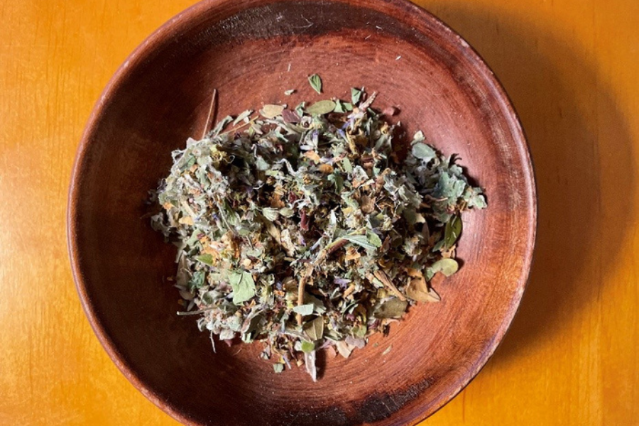 Bowl of medicine in a bowl on an orange background.