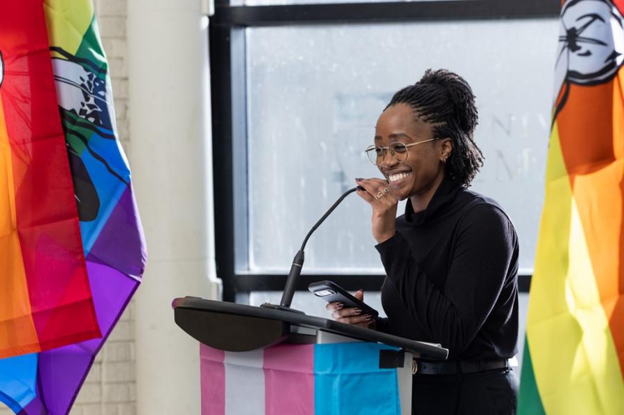 Young woman standing at a podium and smiling ready to speak