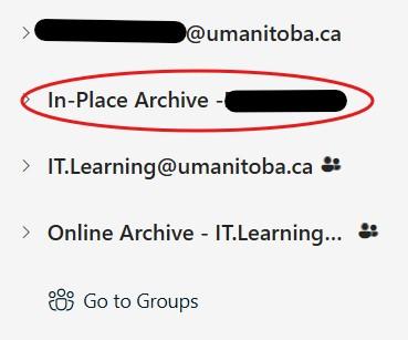 The image shows a cropped section of an Outlook email client On the left side, a line of text reads: “In-Place Archive - with name text blacked out.