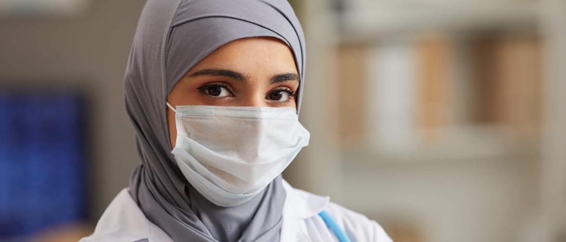 Physician wearing a mask.