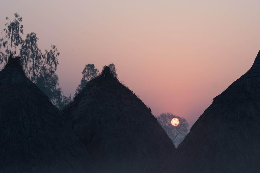 Village houses with sunset overhead.