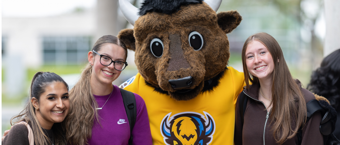 A group of students posing with Billy the Bison