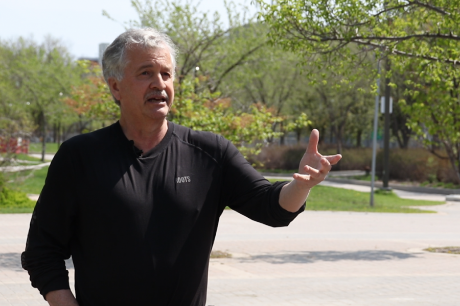 Dr. Brian Rice outside gesturing forwards