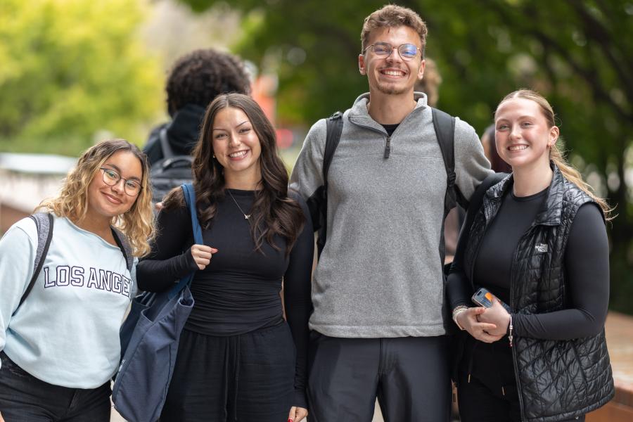 A group of students smiling together outside