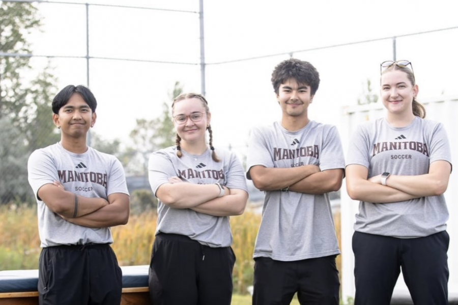 A group of athletic therapy students posing with their arms crossed